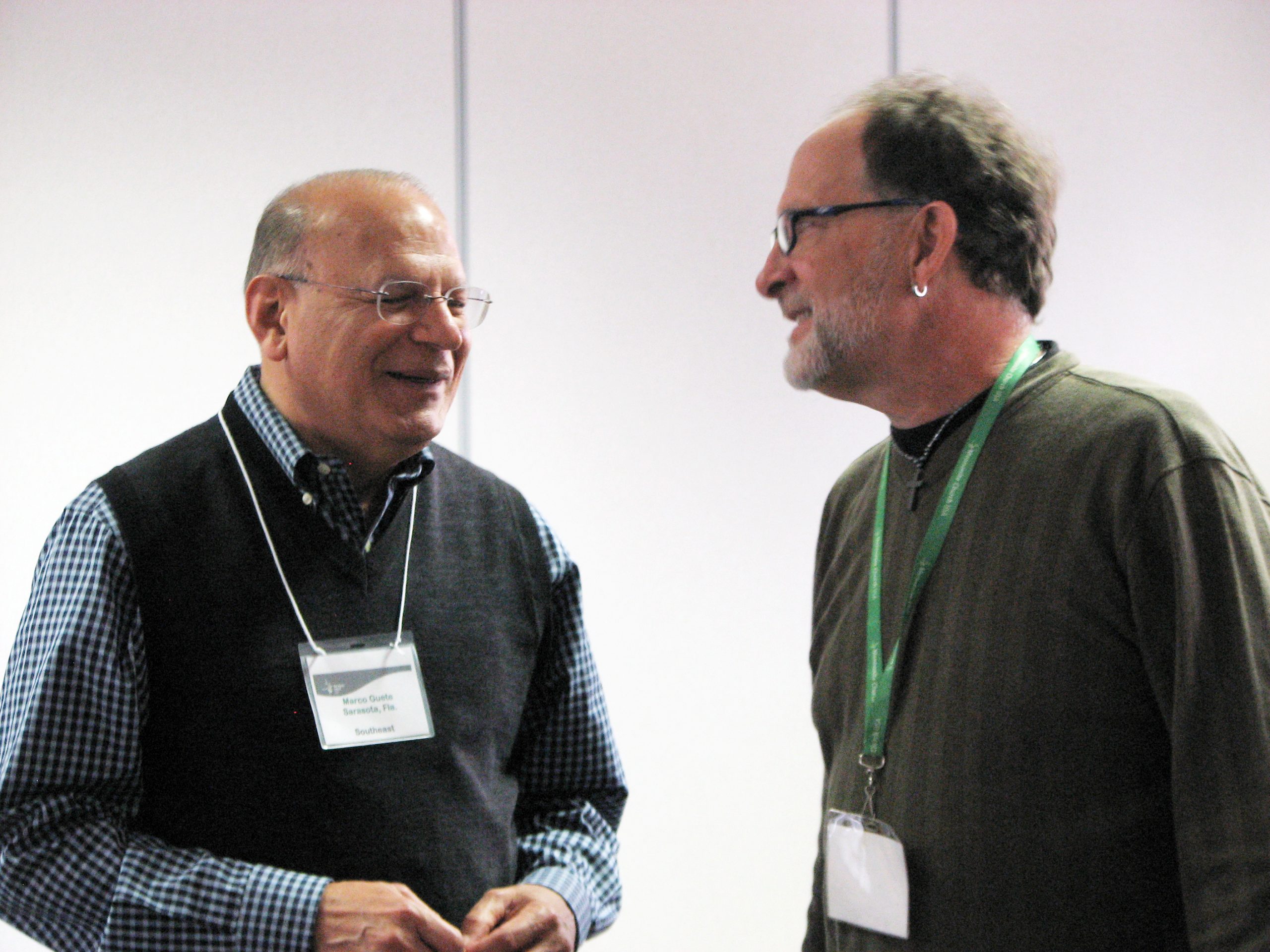 Marco Güete, executive conference minister for Southeast Mennonite Conference, talks with Michael Zehr, Southeast Mennonite Conference moderator, at the March Constituency Leaders Council meeting at Silverwood Mennonite Church in Goshen, Indiana. (Photo by Annette Brill Bergstresser)