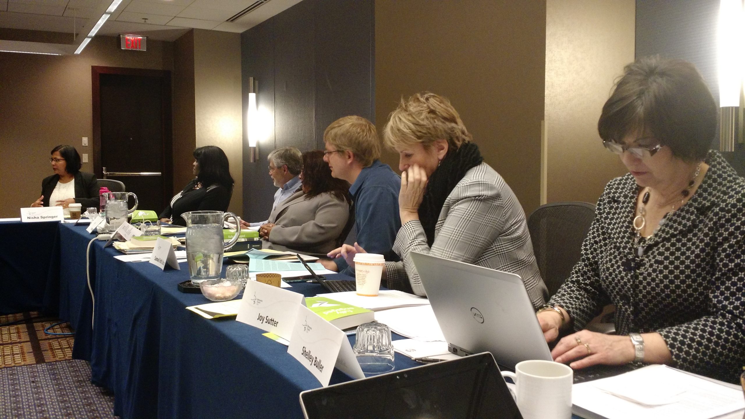 Mennonite Church USA Executive Board members at their February 2016 meeting near Chicago: (left to right) Nisha Springer, Zenobia Sowell-Bianchi, Larry Hauder, Yvonne Diaz, Samuel Voth Schrag, Joy Sutter, Shelley Buller (EB staff). (Photo by Janie Beck Kreider)