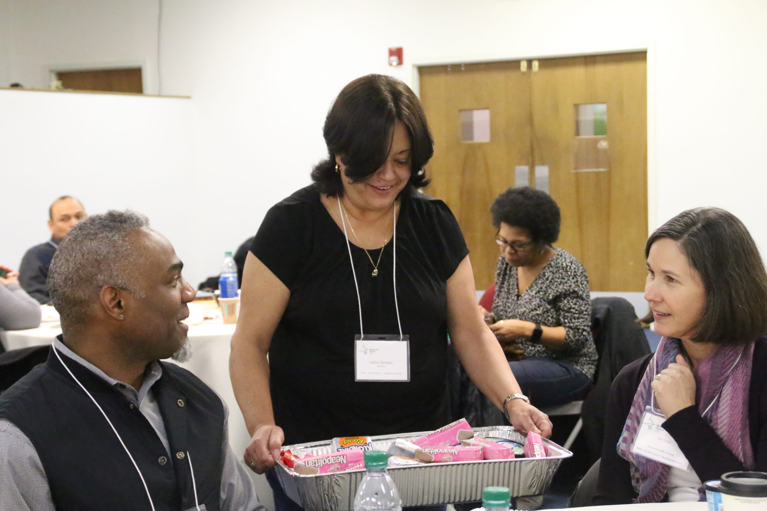 Celina Romero (standing) of Mennonite Education Agency shares with Ewuare Osayande of Mennonite Central Committee and Mim Shirk of MHS as they participate in a work group.