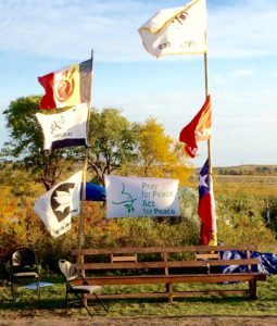 Some Mennonites must have been at Sacred Stone Camp before us! Among the flags raised there was this “Pray for Peace, Act for Peace” banner. Photo credit: Ken Gingerich