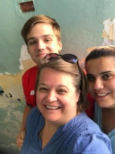 Photo of Amy Yoder McGloughlin and son, Will, visiting with CPT Palestine Team Leader Mona Al Zuhairi (right) in 2018.