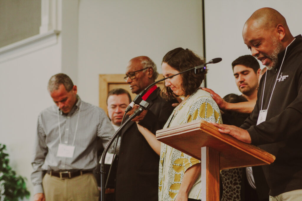 Glen Guyton praying at Mosaic Mennonite Conference Assembly