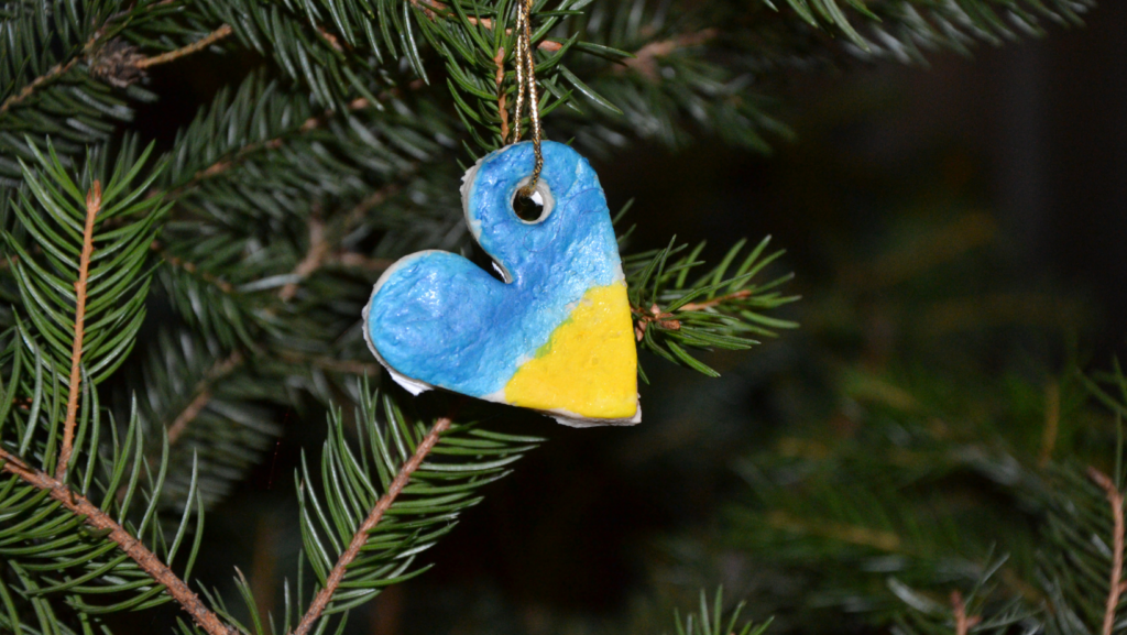 Heart-shaped Christmas ornament painted blue and yellow