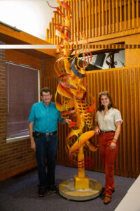 John Mishler and Emma Zuercher with a metal sculpture