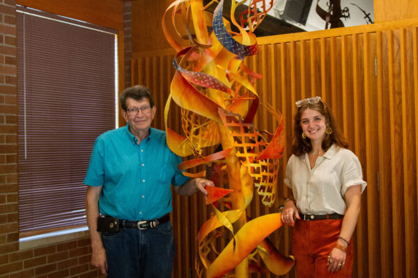 John Mishler and Emma Zuercher with a metal sculpture